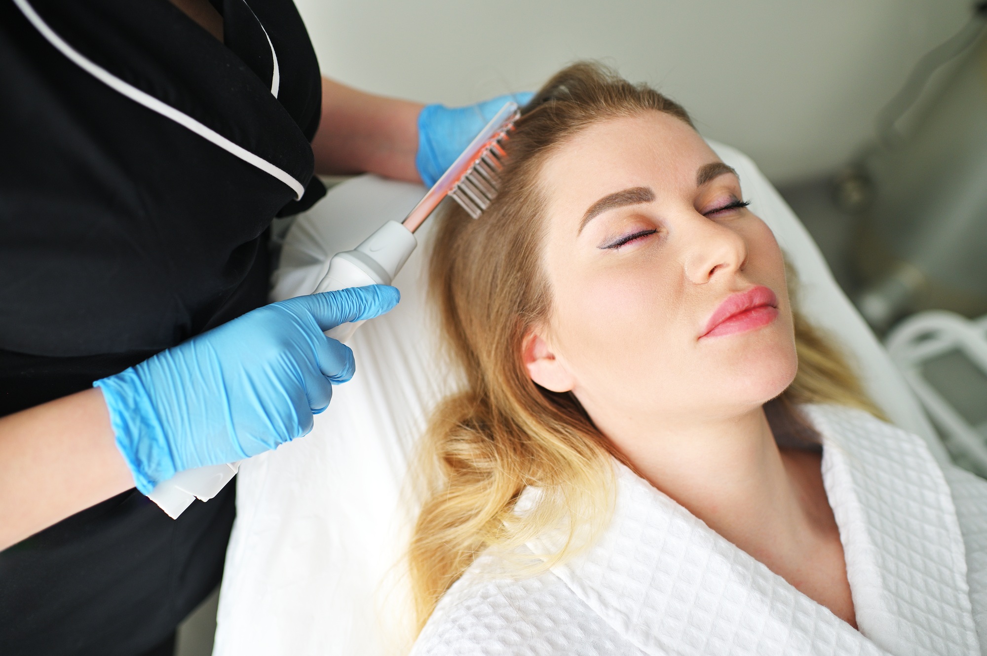 dermatologist trichologist performs the procedure with a darsonval device to improve the condition