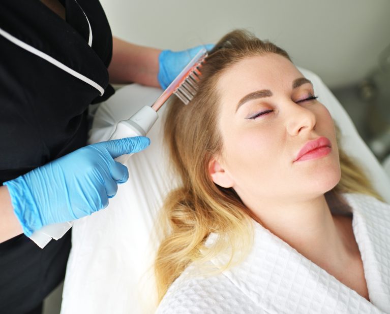 dermatologist trichologist performs the procedure with a darsonval device to improve the condition